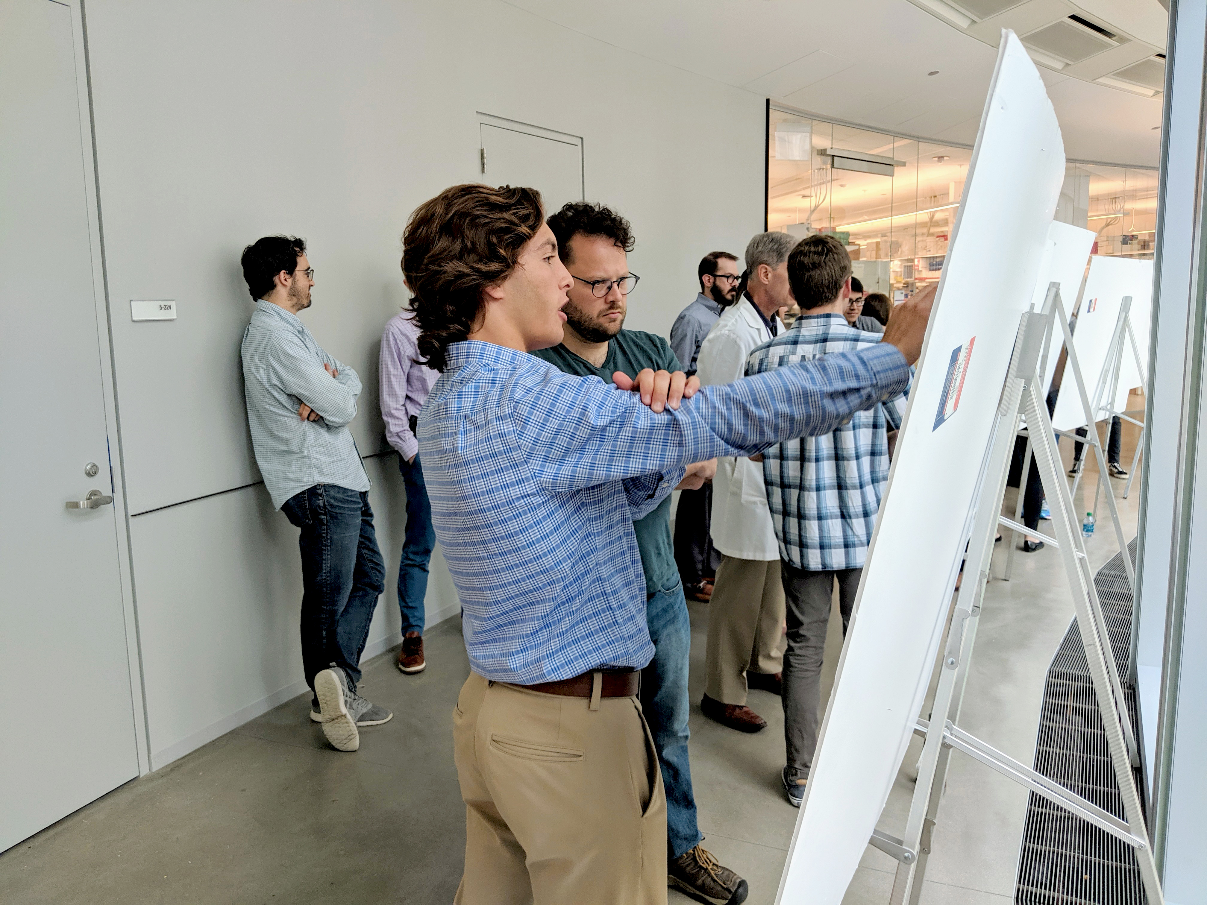 Interns present their posters at the Summer Research Symposium