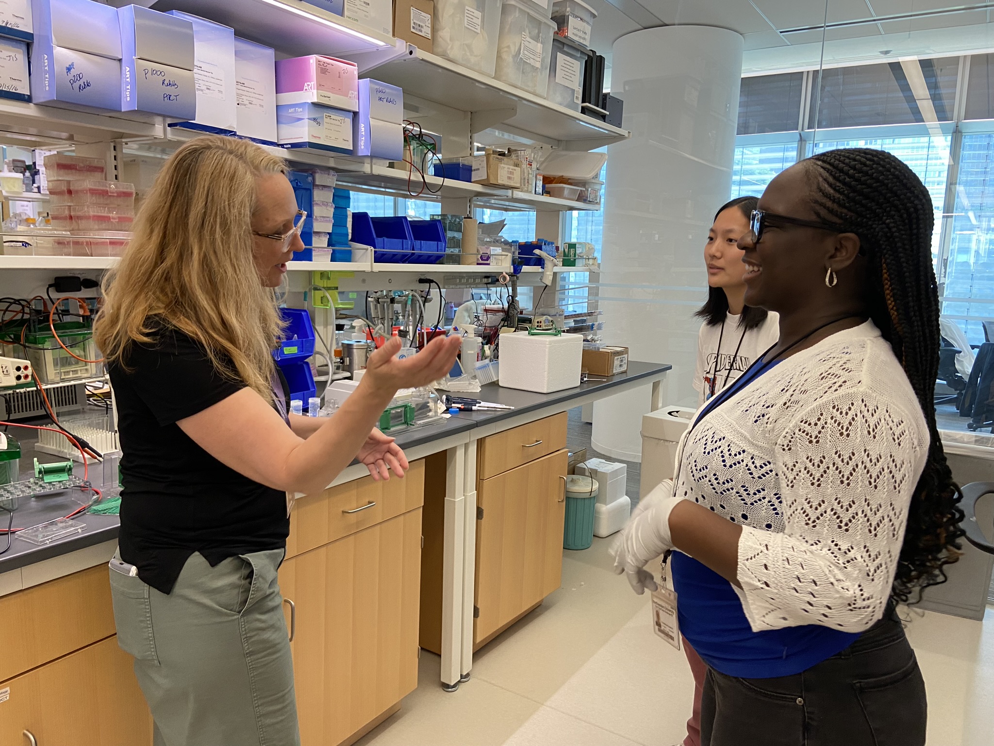 A scientist describes an experiment to two interns in the laboratory